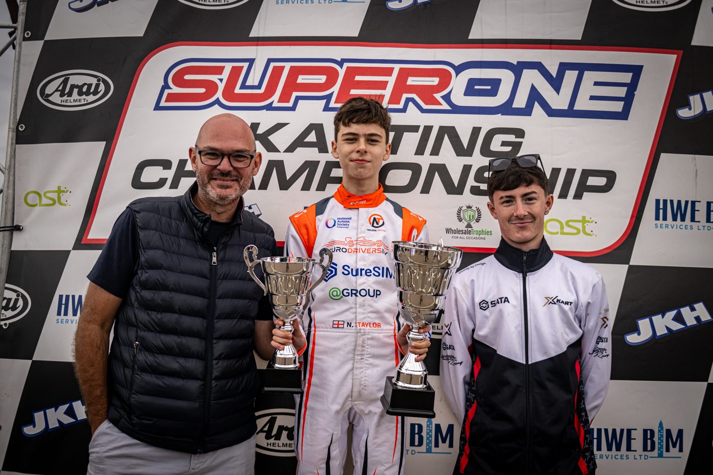 Nelson Taylor celebrating on the podium with his team